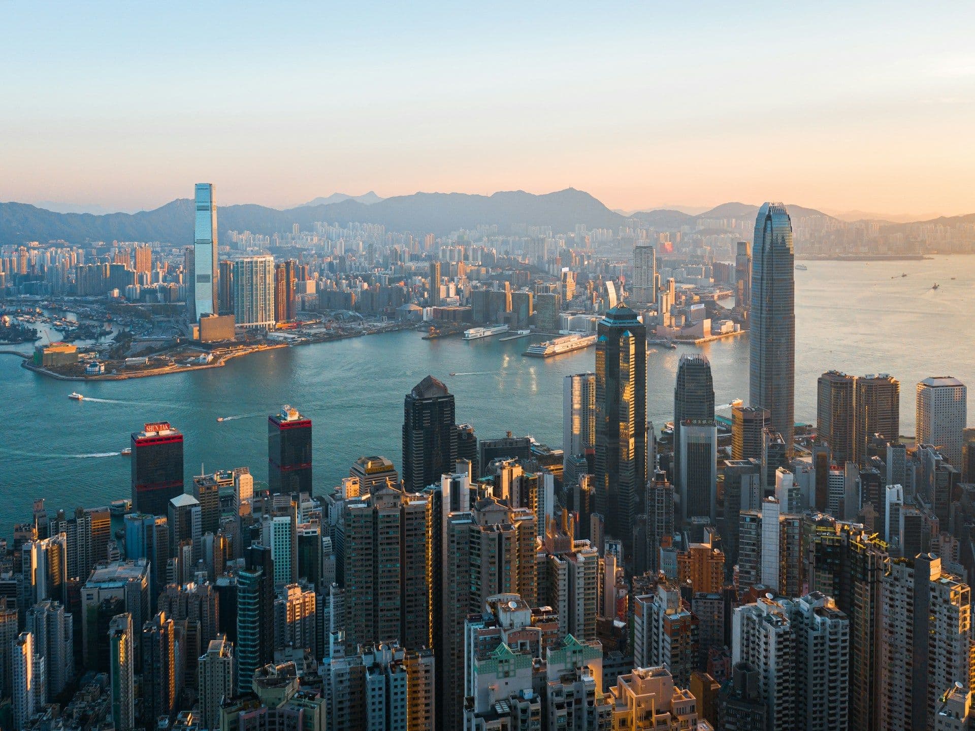 Hong Kong skyline with digital assets and stablecoin icons overlay, representing regulatory innovation in crypto finance